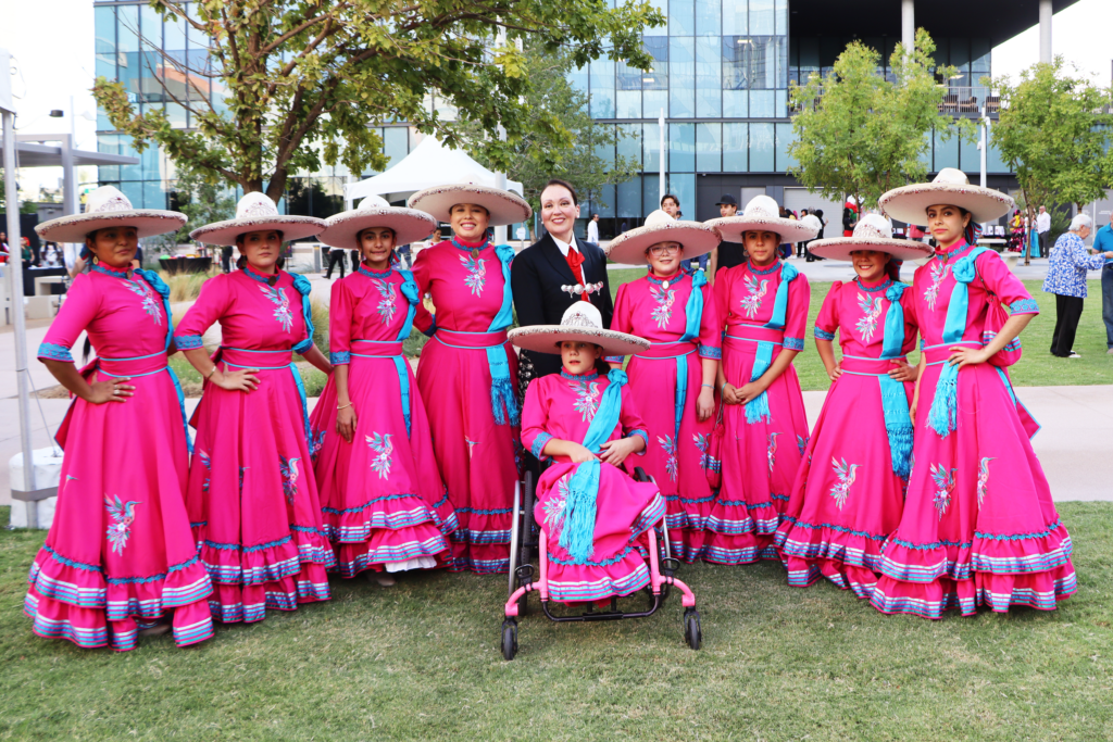 Performers at the El Grito Celebration stop to pose for a photo.