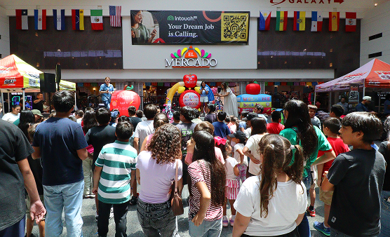 Families gather at El Mercado for back-to-school festivities, complete with colorful decorations and community fun.